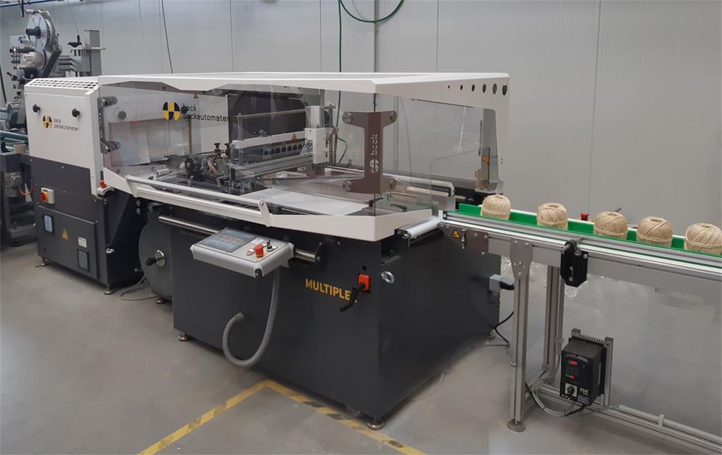 Automated shrink-wrapping line